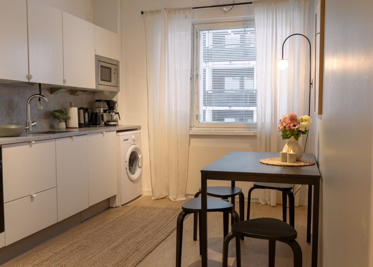 Experience authentic Lapland comfort combined with privacy, nature, and unforgettable Arctic views. Artic City Apartment kitchen.